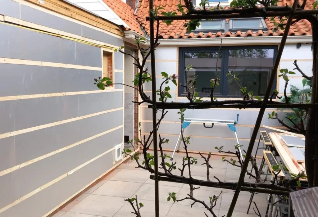 Exterior wall cladding installation in progress